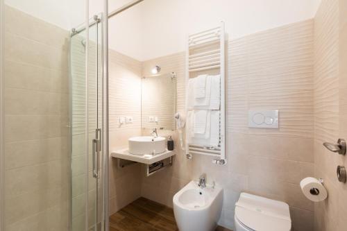 a bathroom with a sink and a toilet and a shower at Queen Meg Roma in Rome