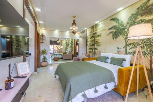 a bedroom with a large bed with plants on the wall at L'Atlas - Appartement Authentique à Gueliz in Marrakesh
