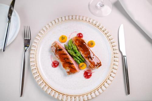 a white plate with some food on a table at Hotel Sunce in Soko Banja