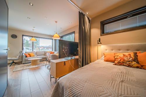 Levillas Platinum 2B2 في ليفي: غرفة نوم مع سرير وغرفة معيشة