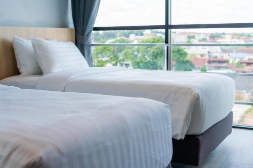 Ένα ή περισσότερα κρεβάτια σε δωμάτιο στο Goodday Hotel