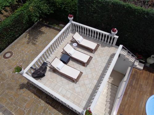 an overhead view of a patio with chairs and a table at Apartments Butinar Pri Kapitanu in Ankaran