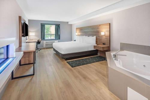 a hotel room with a bed and a sink at Super 8 by Wyndham Cornwall ON in Cornwall