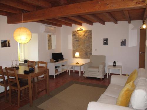 a living room with a white couch and a table at Casa do Castelo - Coroa in Castelo de Vide