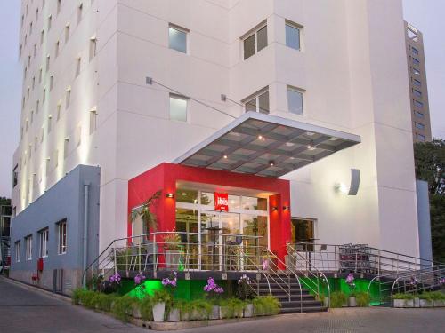 a white building with a red and white at ibis Asuncion in Asuncion