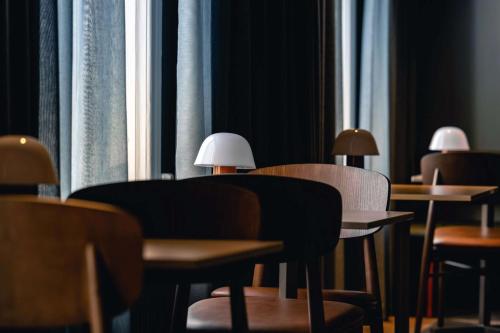 a row of tables and chairs in a room with windows at Best Western Solhem Hotel in Visby