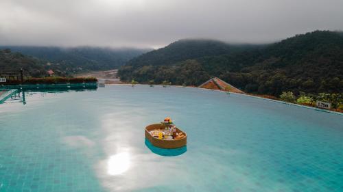 a boat in the middle of a large pool of water at Le Grand Cruise Package in Pakbeng