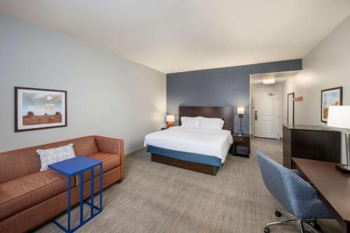 a hotel room with a bed and a couch at Hampton Inn & Suites Phoenix North/Happy Valley in Phoenix