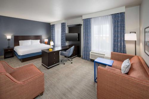 a hotel room with a bed and a desk at Hampton Inn & Suites Phoenix North/Happy Valley in Phoenix