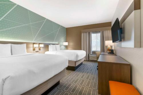 a hotel room with two beds and a television at Comfort Inn & Suites Port Charlotte-Punta Gorda in Port Charlotte
