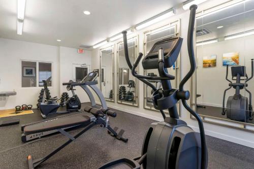 a gym with three tread machines in a room at Comfort Inn & Suites Port Charlotte-Punta Gorda in Port Charlotte