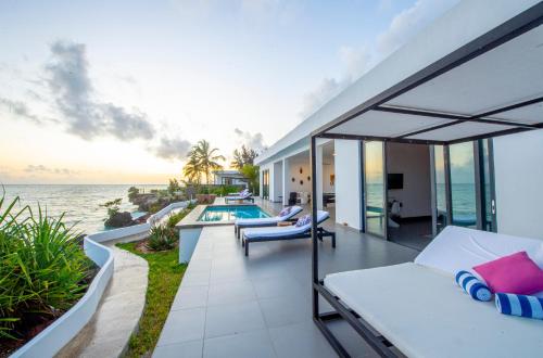 a balcony of a house with a swimming pool at Safira Blu Luxury Resort & Villas in Nungwi