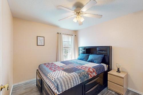 a bedroom with a bed and a ceiling fan at Killeen Serene in Killeen