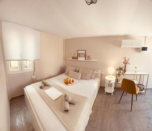 a bedroom with a large white bed and a table at Cactus Luxury suite1 in Athens