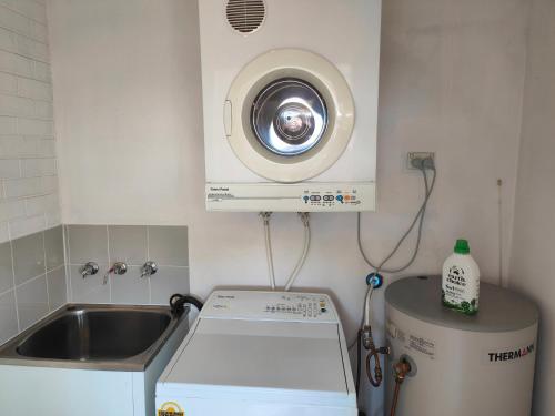 a kitchen with a washing machine and a dryer at Tuggeranong Short Stay #06C - Sleeps 6 in Canberra