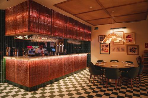 a restaurant with a counter and a table with chairs at Hotel Casa Bassa in Valencia