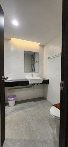 a bathroom with a sink and a toilet at Prom Hotel in Bangkok