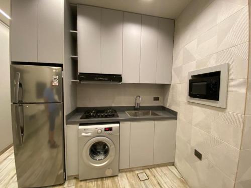 a kitchen with a refrigerator and a washing machine at Stunning Sea Front Chalet In Tripoli in Trâblous