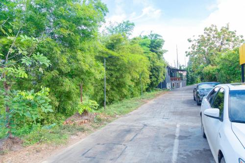 a street with cars parked on the side of the road at Bouasavan Hotel and Garden in Savannakhet