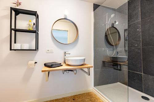 a bathroom with a sink and a mirror at Le Gîtel in Spa