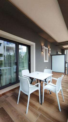 a dining room with a table and chairs and a screen at Porto Marine Hotel in Platamonas