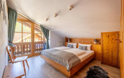 a bedroom with a large bed and a window at Ferienwohnung Rauschbergblick in Ruhpolding