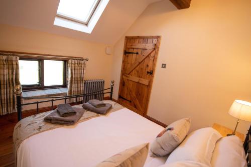 a bedroom with a bed and a window and a couch at The Threshing Barn in Woodhall Spa