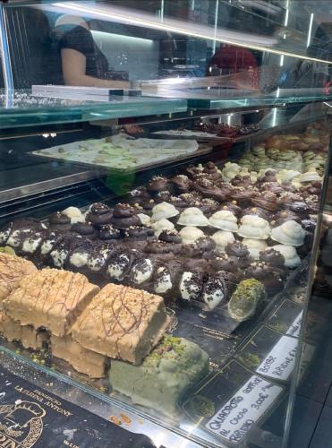 a display case filled with lots of different types of pastries at Catania Apartment Borgo Suite Autonomous in Catania