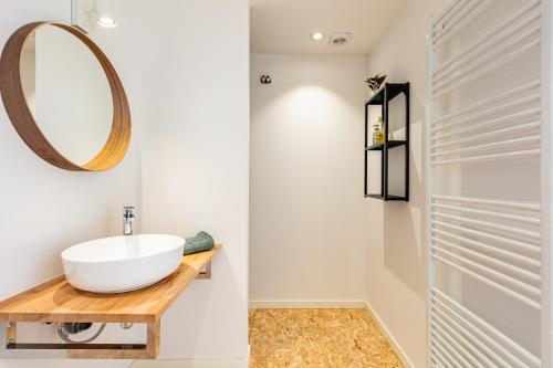 a bathroom with a sink and a mirror at Le Gîtel in Spa