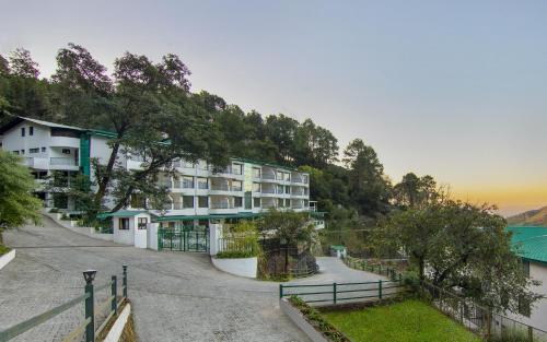arial view of a building with a mountain at Sterling Nainital in Nainital