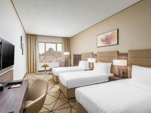 Postel nebo postele na pokoji v ubytování Wirgan Hotel Al Nour
