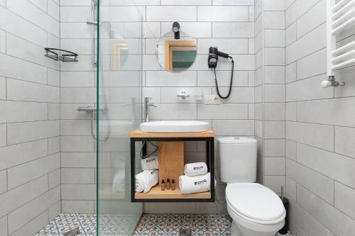 a bathroom with a toilet and a sink and a shower at Intourist Kazbegi in Stepantsminda