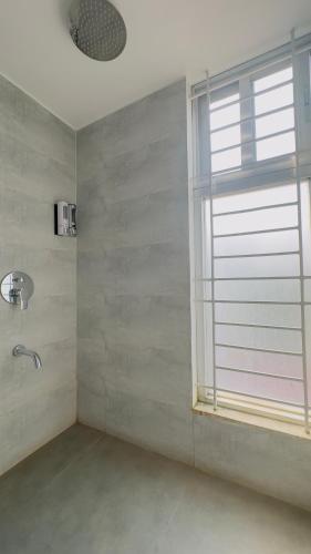 a bathroom with a window and a sink at Priyo Nibash Stylish Residential Hotel in Dhaka