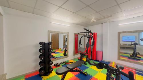 a gym with several treadmills and treadles in a room at Priyo Nibash Stylish Residential Hotel in Dhaka