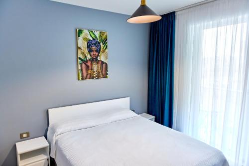 a bedroom with a white bed and a window at Apartamente Indigo Alezzi Beach Pool & Spa in Mamaia Sat/Năvodari