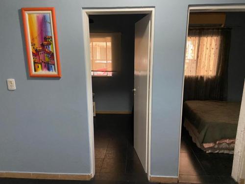 a hallway with a door to a room with a bed at "Edificio Don Luis" en Bajada Vieja in Posadas