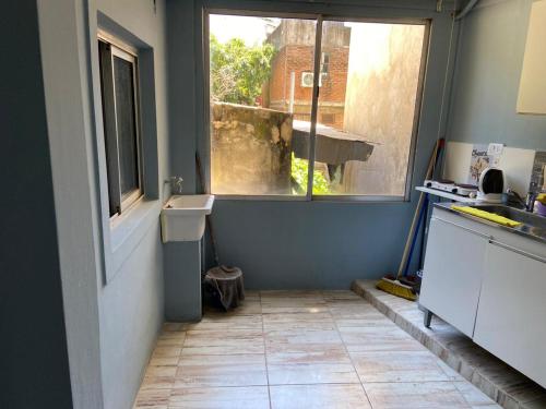 a small kitchen with a sink and a window at "Edificio Don Luis" en Bajada Vieja in Posadas
