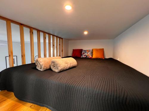 a bedroom with a large bed with two pillows on it at Apartament CALM Przy Rynku z klimatyzacją i parkingiem in Kielce