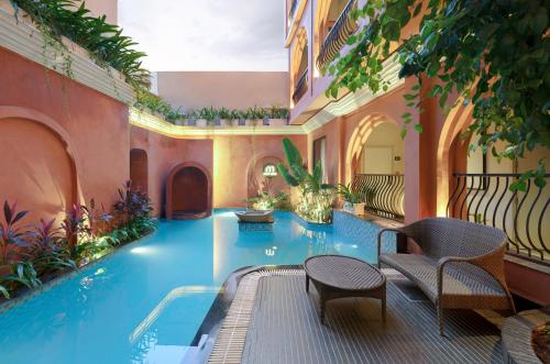 a swimming pool in the middle of a building at The Red Pier by Downtown Udaipur in Udaipur