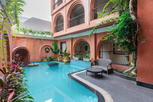 a swimming pool in the middle of a building at The Red Pier by Downtown Udaipur in Udaipur