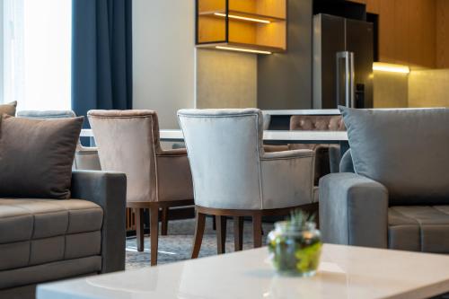 a living room with chairs and a table at Queen of Zlatibor in Zlatibor