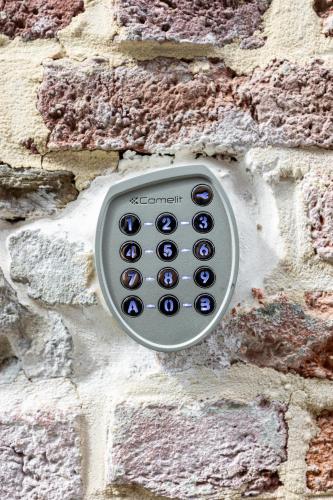 a remote control attached to a brick wall at Le Gîtel in Spa