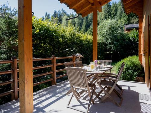 a table and chairs on a patio with a fence at Chalet Miranda by Interhome in Champex
