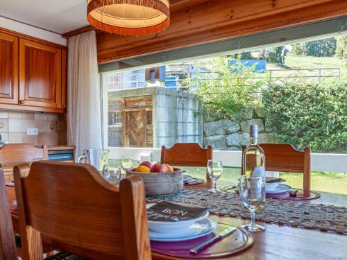 a table with a bowl of fruit and a bottle of wine at Apartment Hauts De Nendaz B OP by Interhome in Nendaz