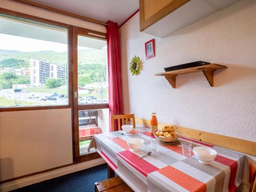 a dining room with a table and a window at Apartment Sarvan 625 by Interhome in Les Menuires