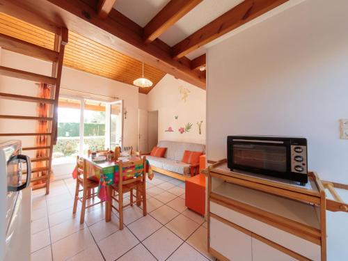 a kitchen and living room with a table and a couch at Holiday Home Marais by Interhome in Vaux-sur-Mer