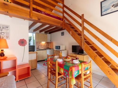 une cuisine et une salle à manger avec un escalier en bois dans l'établissement Holiday Home Marais by Interhome, à Vaux-sur-Mer
