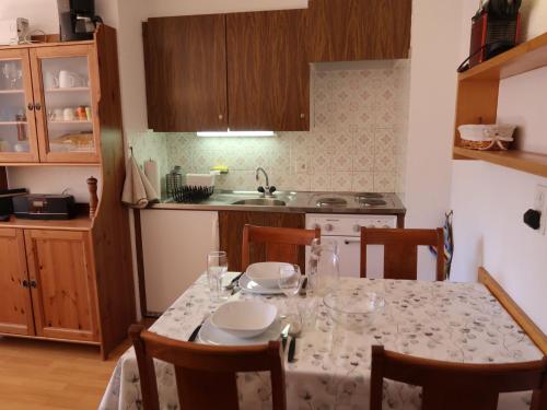 a kitchen with a table with plates and glasses on it at Studio Les Erables Apt 361 by Interhome in Zinal