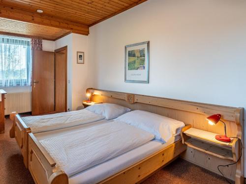 a bedroom with two beds and a lamp in it at Apartment Alpenrose Apartment 2 by Interhome in Sankt Urban