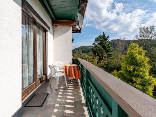a balcony with two chairs and a table and a view at Apartment Alpenrose Apartment 2 by Interhome in Sankt Urban
